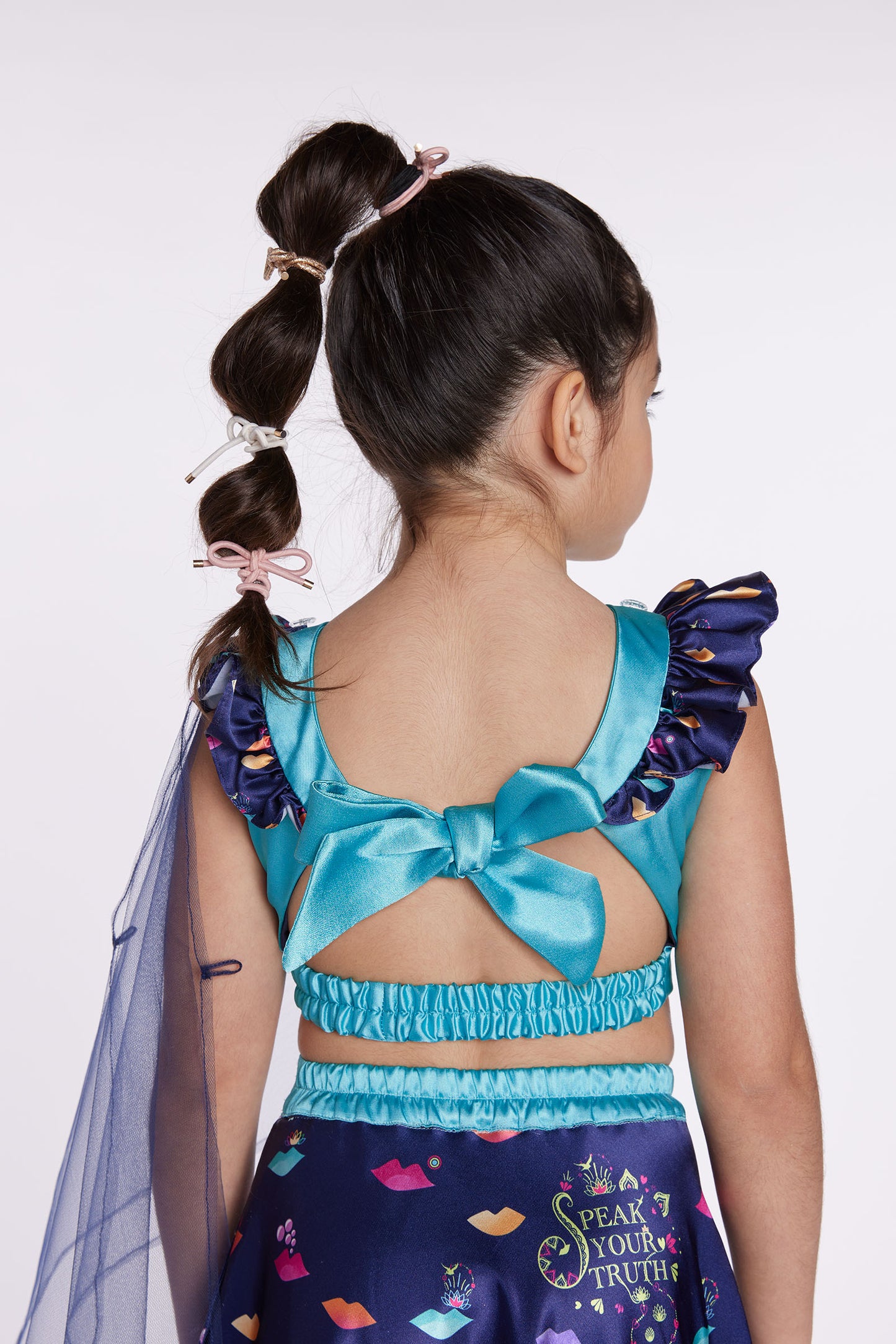 Girl wearing blue lehenga party dress back close