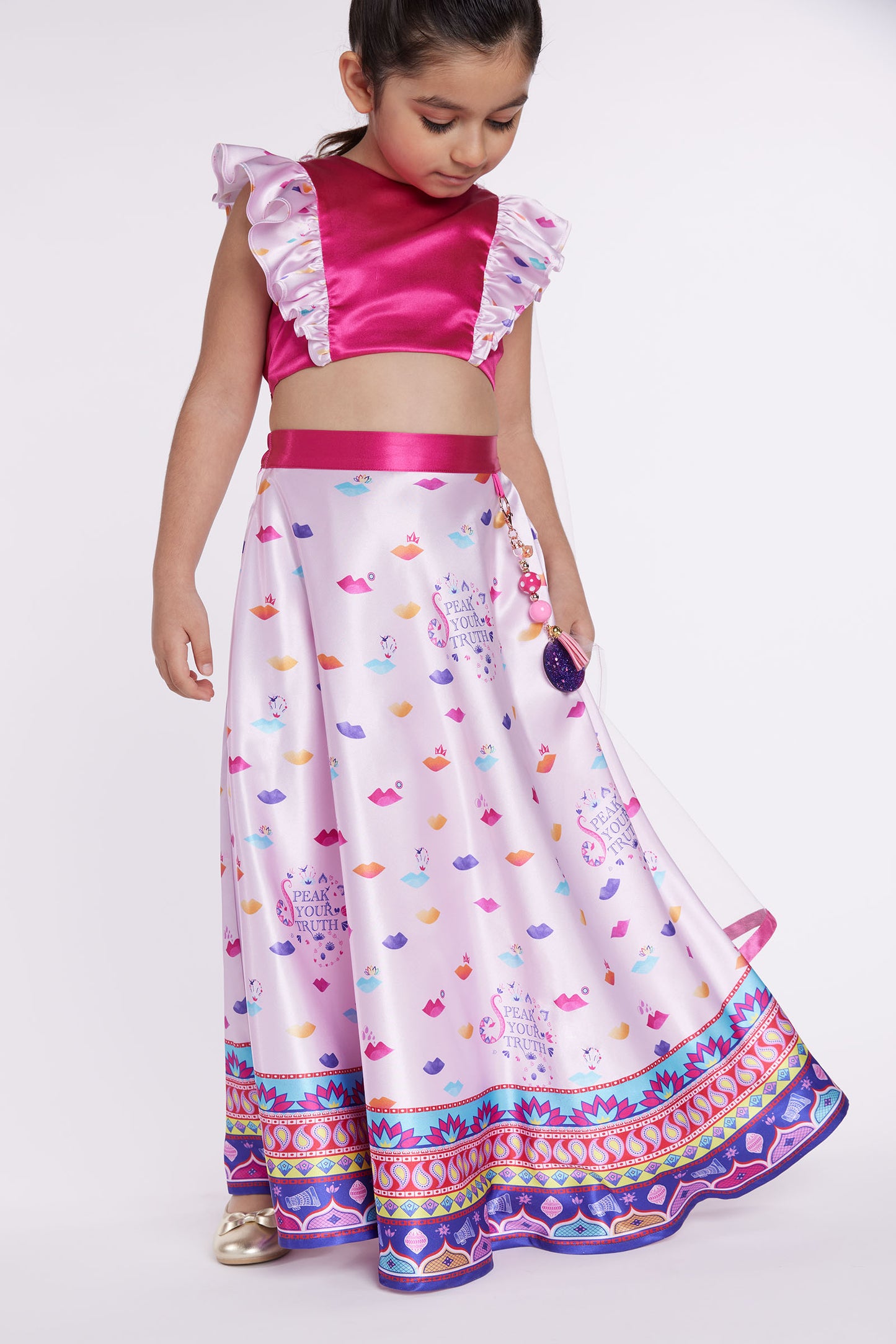 girl wearing pink lehenga front looking down