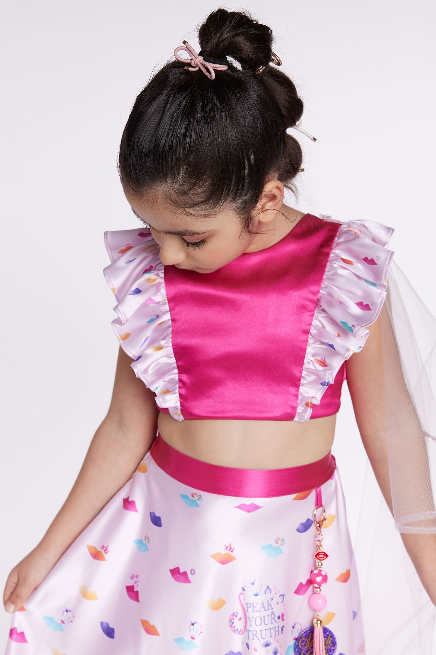 girl wearing pink lehenga party dress front looking down close