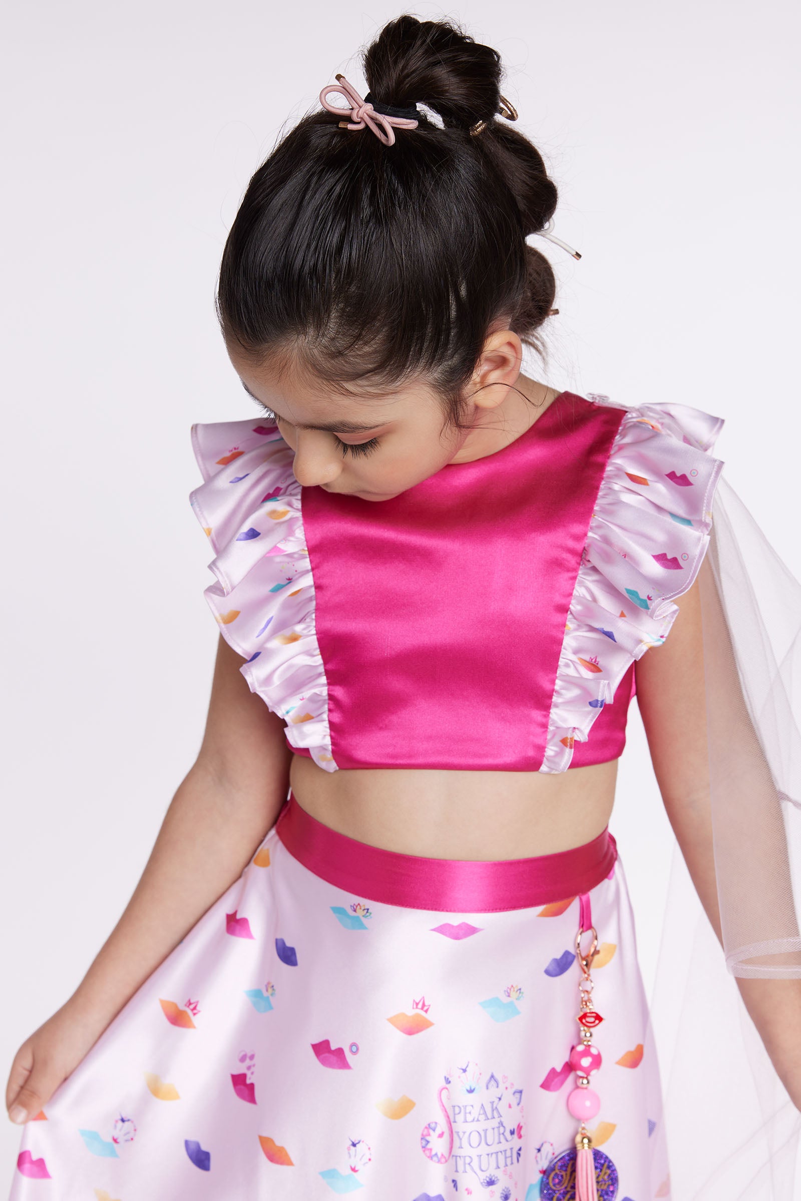 girl wearing pink lehenga party dress front looking down close